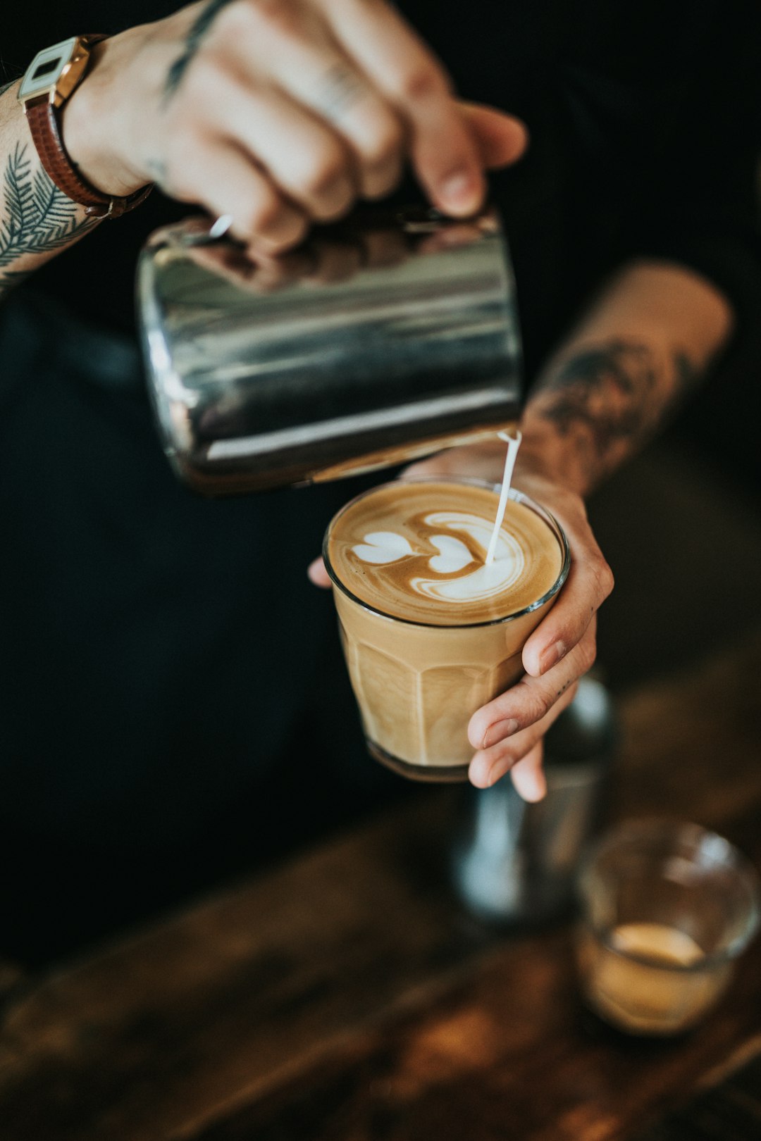 man-pouring-milk-in-coffee-2z3mob3kfju